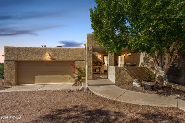 pueblo-style house featuring stucco siding