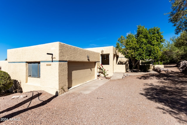 southwest-style home featuring a garage