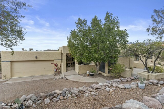doorway to property featuring ceiling fan, a patio area, and stucco siding