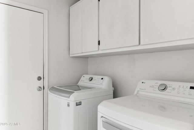 laundry area featuring cabinets and washer and dryer