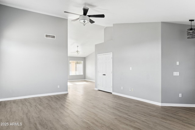 empty room featuring high vaulted ceiling, hardwood / wood-style floors, and ceiling fan