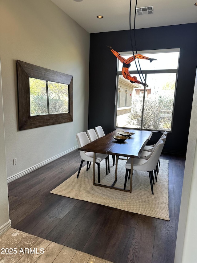 dining room with hardwood / wood-style flooring, baseboards, and visible vents