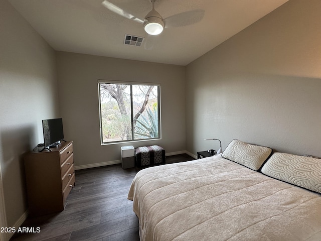 bedroom featuring ceiling fan, visible vents, baseboards, and dark wood-style floors