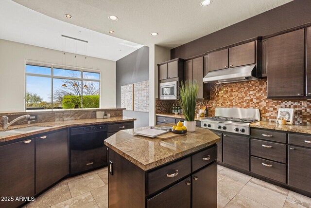 kitchen with a kitchen island, under cabinet range hood, decorative backsplash, appliances with stainless steel finishes, and a sink