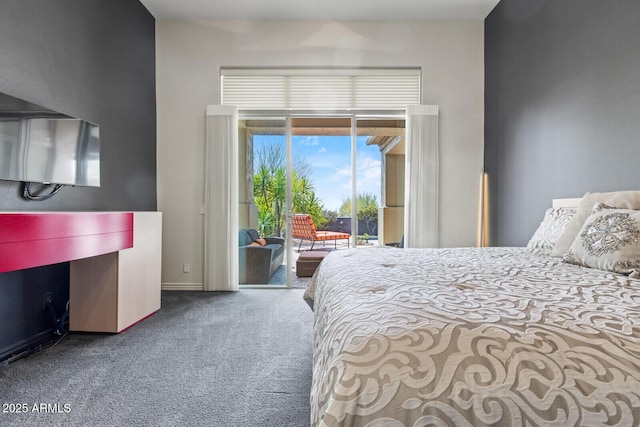carpeted bedroom featuring baseboards and access to exterior