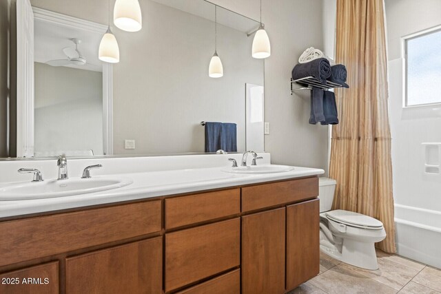 full bathroom featuring double vanity, shower / bath combination with curtain, toilet, and a sink