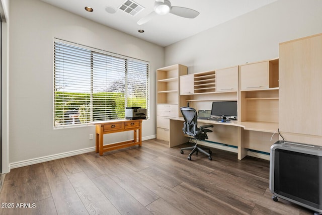 office featuring wood finished floors, a ceiling fan, visible vents, and baseboards