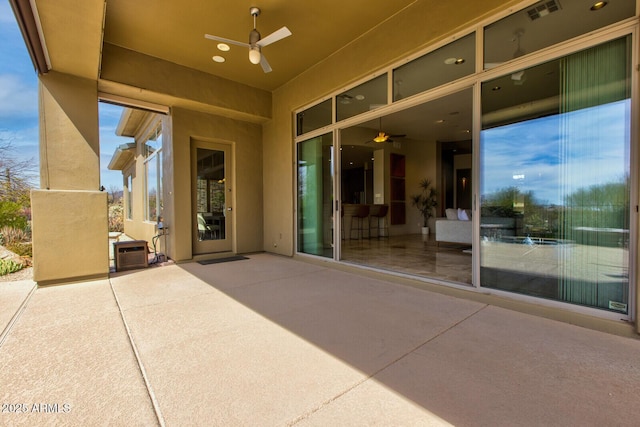 view of patio / terrace with a ceiling fan and visible vents