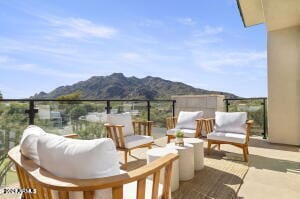 view of terrace with a mountain view and a balcony