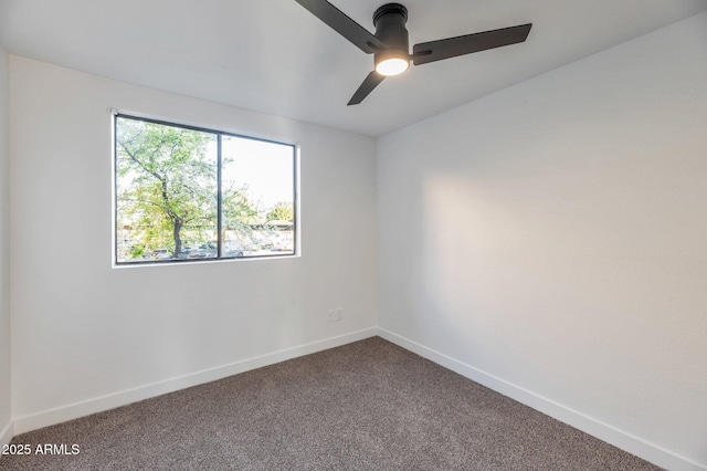 spare room with ceiling fan, carpet flooring, and baseboards