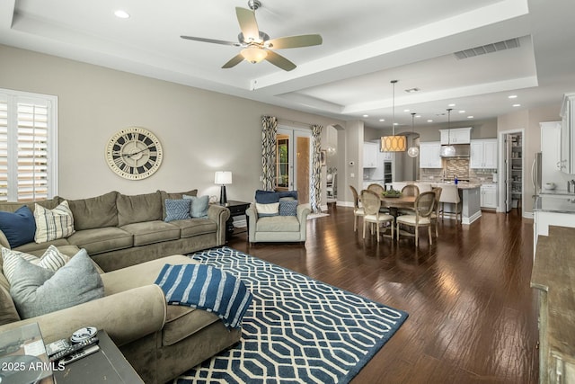 2051 E Aris Dr, Gilbert, AZ 85298 - living room with dark wood-type flooring, a raised ceiling, visible vents, and a ceiling fan