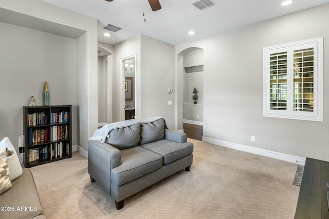 2051 E Aris Dr, Gilbert, AZ 85298 - living room with arched walkways, ceiling fan, visible vents, and light carpet