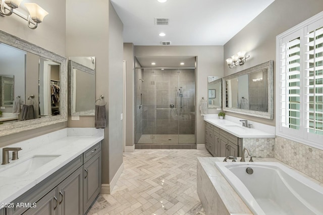 2051 E Aris Dr, Gilbert, AZ 85298 - full bathroom featuring a garden tub, visible vents, a sink, and a stall shower