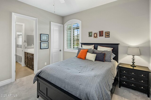 2051 E Aris Dr, Gilbert, AZ 85298 - bedroom with light carpet, a ceiling fan, ensuite bathroom, and baseboards