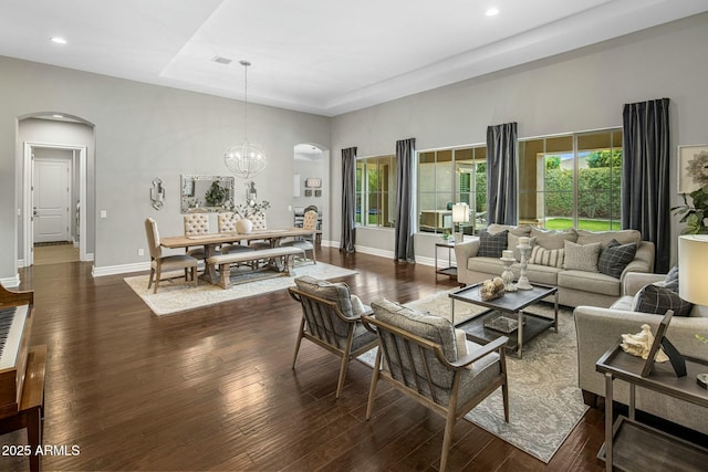 2051 E Aris Dr, Gilbert, AZ 85298 - living room featuring arched walkways, recessed lighting, and dark wood-style flooring