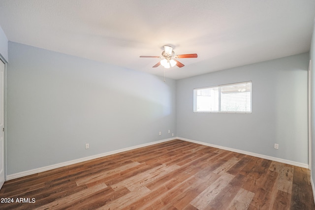 empty room with ceiling fan and hardwood / wood-style flooring