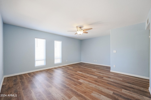 spare room with ceiling fan and dark hardwood / wood-style floors