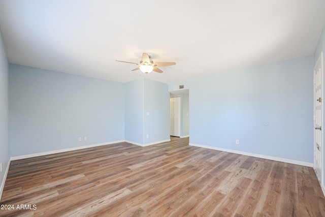 empty room with ceiling fan and light hardwood / wood-style floors