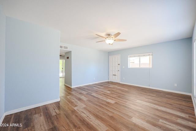 unfurnished room with ceiling fan and hardwood / wood-style flooring