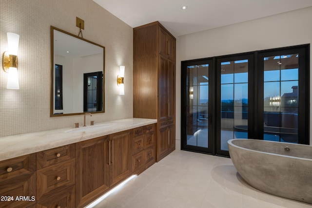 full bath featuring a freestanding tub and vanity