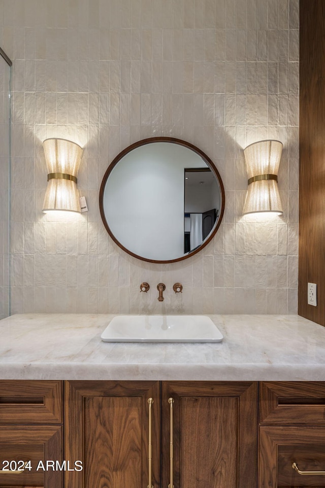 bathroom with tasteful backsplash and vanity