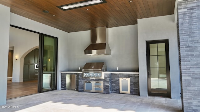 view of patio with area for grilling and a grill