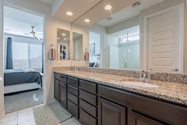 bathroom featuring tile patterned floors, ceiling fan, a shower with door, and a wealth of natural light