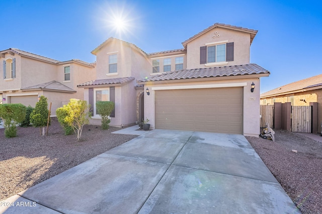 mediterranean / spanish-style home with a garage