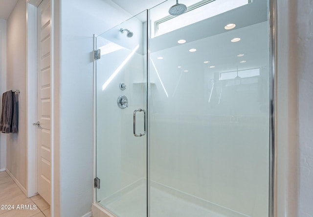 bathroom with tile patterned flooring and walk in shower