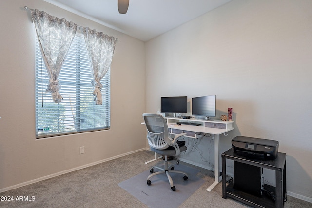 carpeted office space with ceiling fan