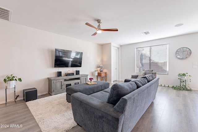 living room featuring light wood-type flooring and ceiling fan