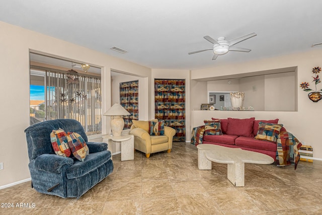 living area featuring visible vents, ceiling fan, and baseboards