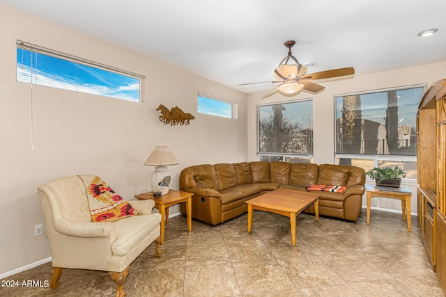 sunroom / solarium featuring a ceiling fan