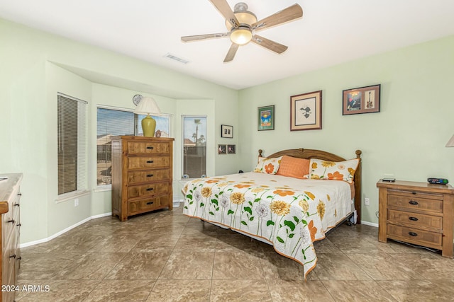 bedroom featuring baseboards, visible vents, and ceiling fan