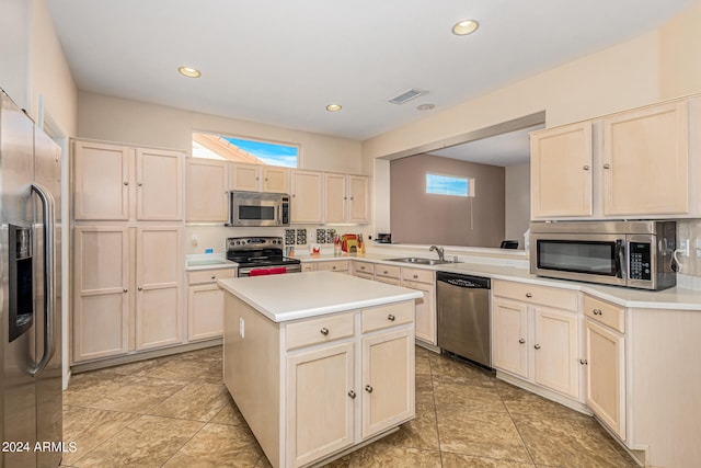 kitchen featuring appliances with stainless steel finishes, a center island, kitchen peninsula, and sink