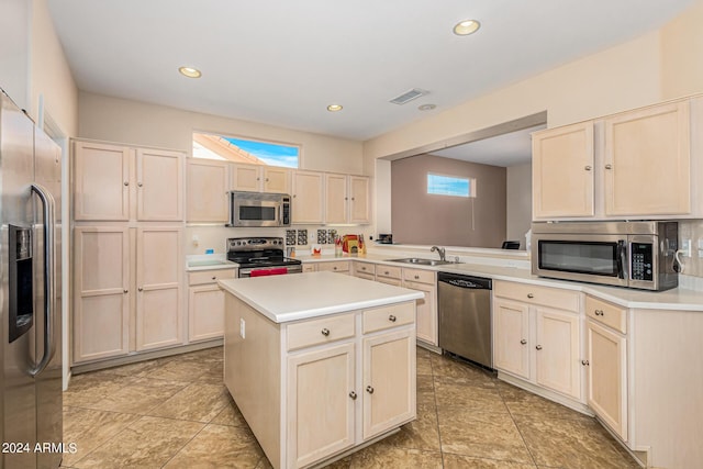 kitchen featuring a center island, light countertops, visible vents, appliances with stainless steel finishes, and a sink