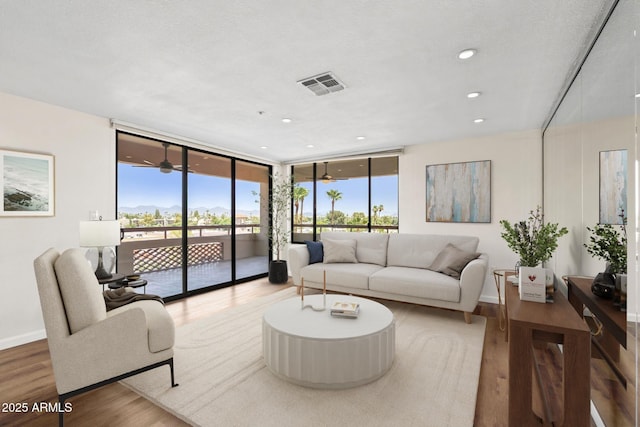 4200 N Miller Rd Unit 504, Scottsdale, AZ 85251 - living area featuring expansive windows, wood finished floors, and recessed lighting