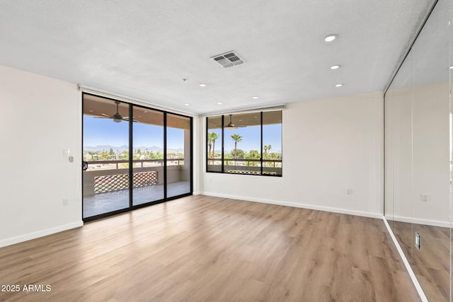 4200 N Miller Rd Unit 504, Scottsdale, AZ 85251 - spare room with light wood-style floors, recessed lighting, and floor to ceiling windows