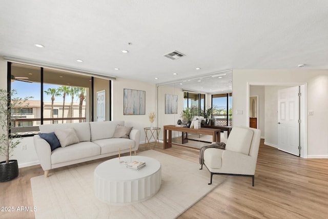 4200 N Miller Rd Unit 504, Scottsdale, AZ 85251 - living area featuring light wood-style flooring, a wall of windows, and recessed lighting