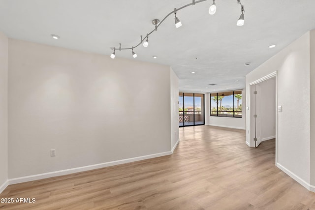 4200 N Miller Rd Unit 504, Scottsdale, AZ 85251 - spare room featuring light wood-style flooring, rail lighting, and recessed lighting