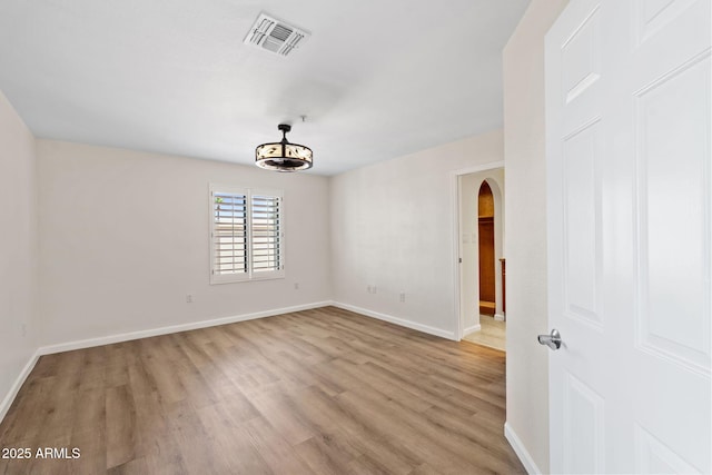 4200 N Miller Rd Unit 504, Scottsdale, AZ 85251 - unfurnished room featuring arched walkways and light wood-type flooring
