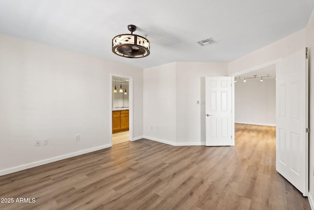 4200 N Miller Rd Unit 504, Scottsdale, AZ 85251 - empty room with rail lighting and light wood finished floors