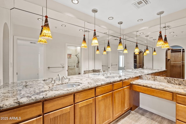 4200 N Miller Rd Unit 504, Scottsdale, AZ 85251 - bathroom with a stall shower, double vanity, wood finished floors, and recessed lighting