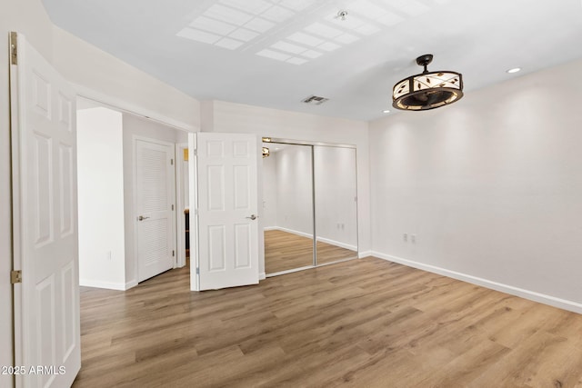 4200 N Miller Rd Unit 504, Scottsdale, AZ 85251 - unfurnished bedroom featuring wood finished floors, a closet, and recessed lighting