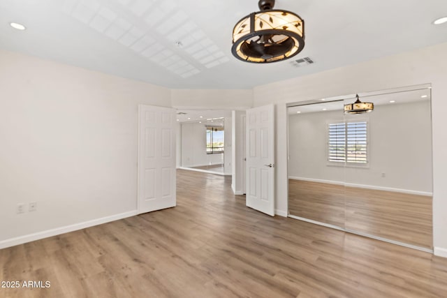 4200 N Miller Rd Unit 504, Scottsdale, AZ 85251 - empty room featuring wood finished floors, plenty of natural light, a chandelier, and recessed lighting