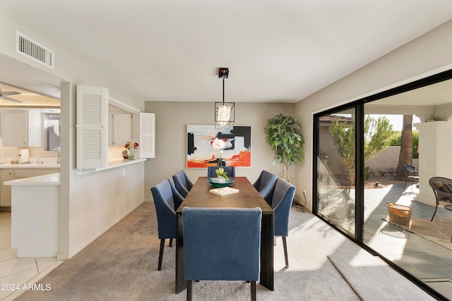 dining space featuring light colored carpet