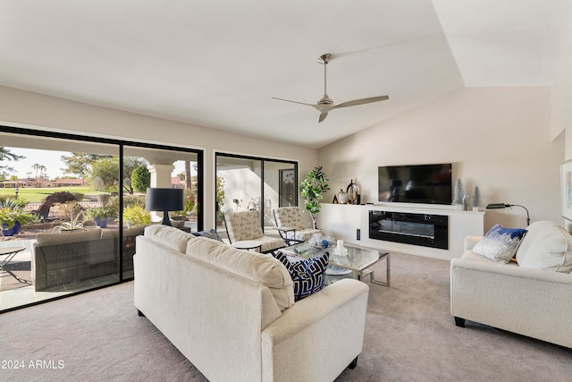 carpeted living room featuring vaulted ceiling and ceiling fan