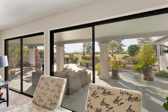 entryway featuring decorative columns and plenty of natural light