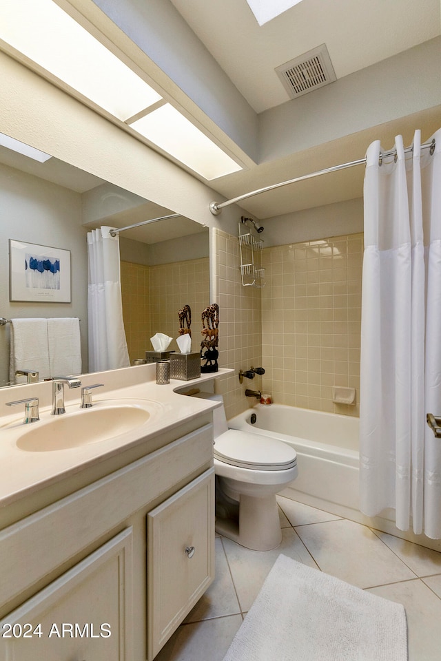 full bathroom with tile patterned flooring, shower / bath combination with curtain, toilet, and vanity