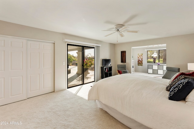 carpeted bedroom with access to exterior, ceiling fan, a closet, and multiple windows